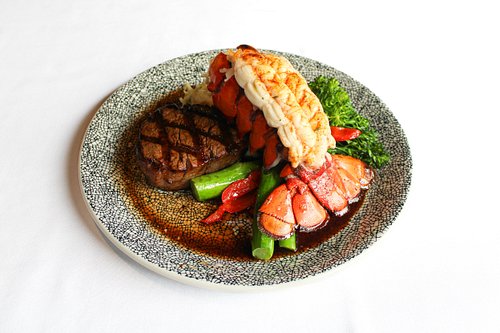Leo’s Grand Rapids signature dishes Seafood Cake Duet, Lobster Bisque, Chargrilled Sea Scallops, Leo's Surf & Turf